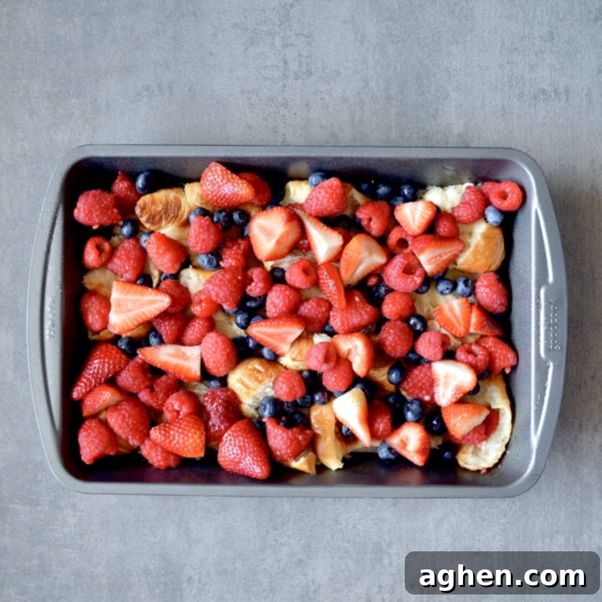 Fresh berries and croissants in a pan