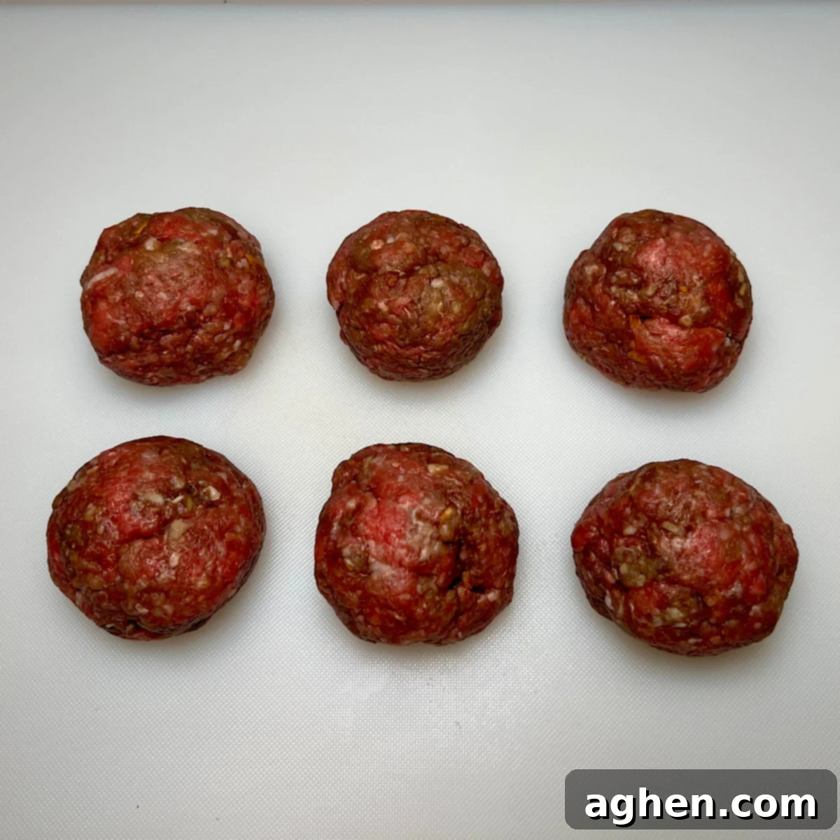 Six individual meatballs for Juicy Lucy burgers ready to be pressed