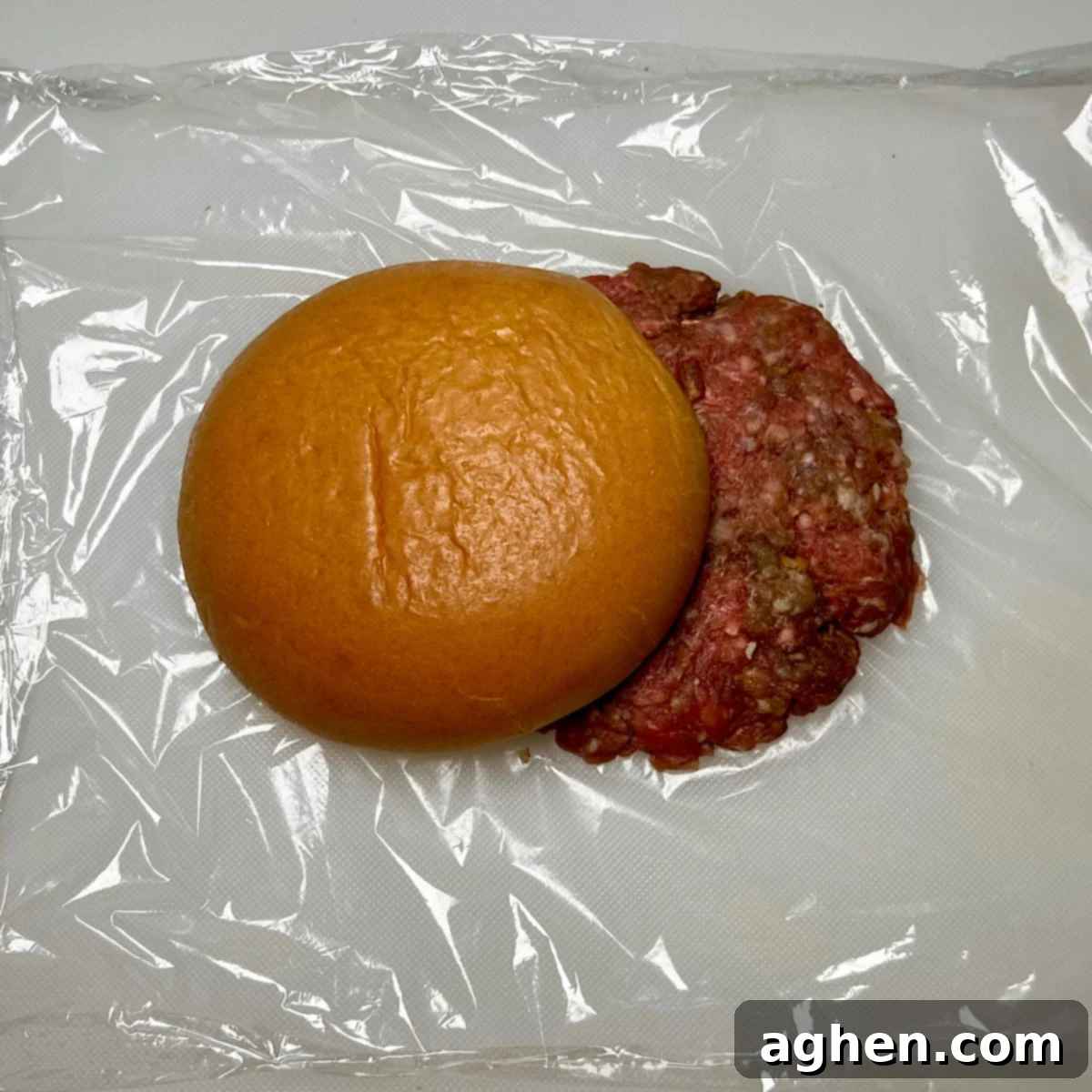 Smashed Juicy Lucy burger patties next to a brioche bun