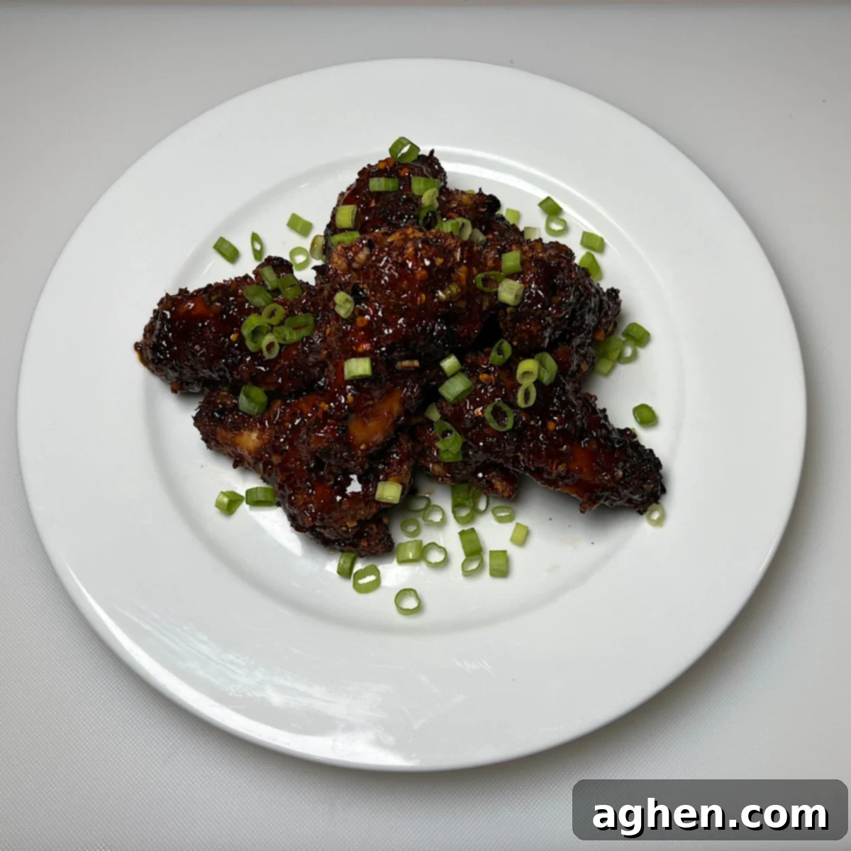 Plated finished Asian-style chicken wings ready to serve