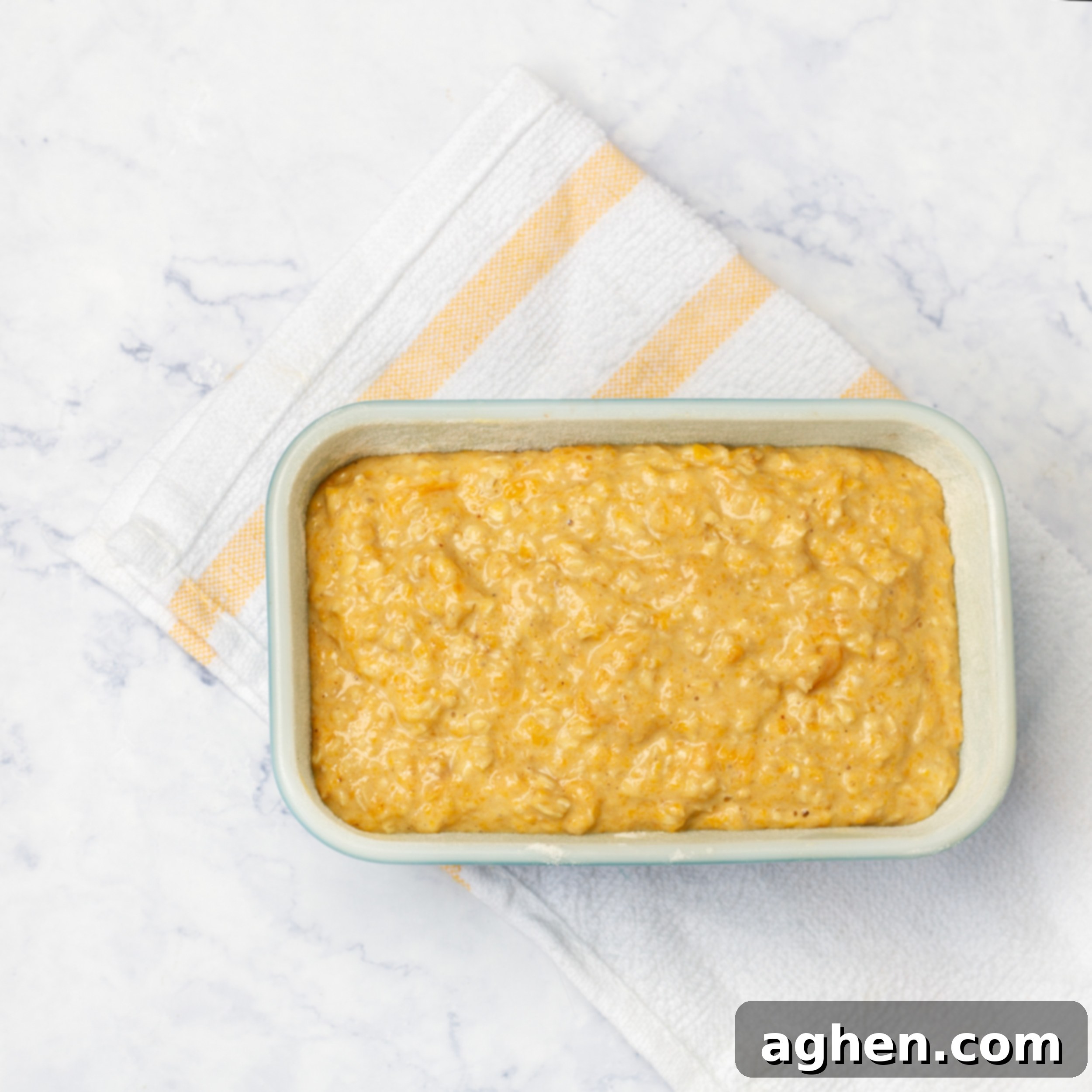 Guilt-Free Spiced Pumpkin Bread 6 The smooth, warmly spiced pumpkin bread batter has been carefully poured and spread evenly into a prepared loaf pan, patiently awaiting its transformative journey in the hot oven.