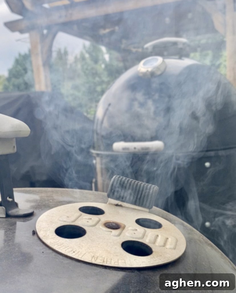 My 30-Year Weber Mastery: Grill Competition-Winning Food 6 Wood chips smoking in a grill, adding flavor to the food.