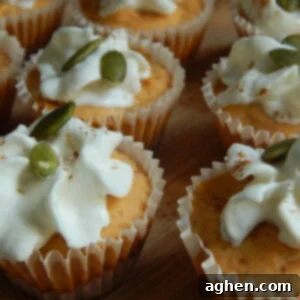 A small, round pumpkin cheesecake bite, showcasing its creamy texture and graham cracker crust