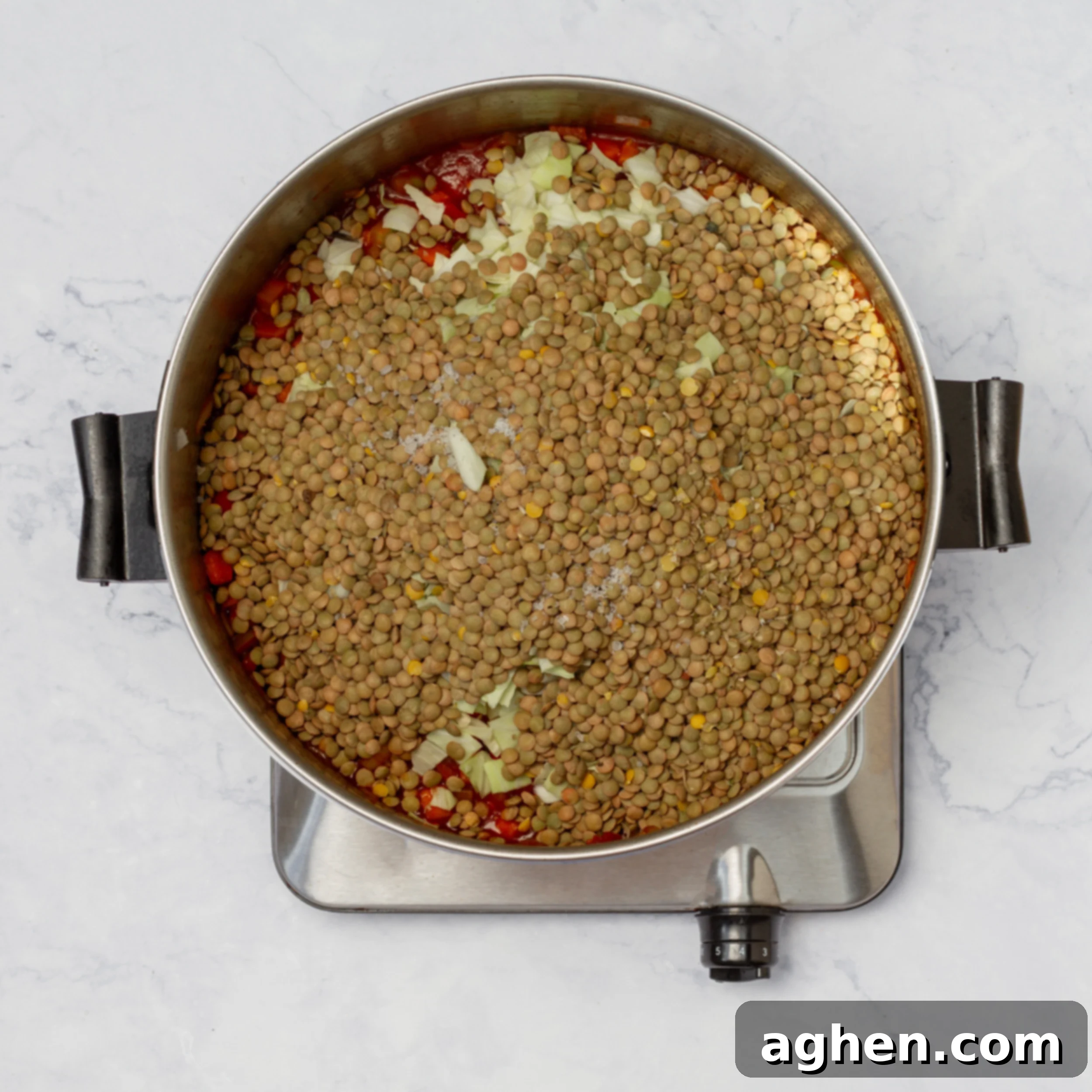 Pot of vegetables and broth with lentils added. 