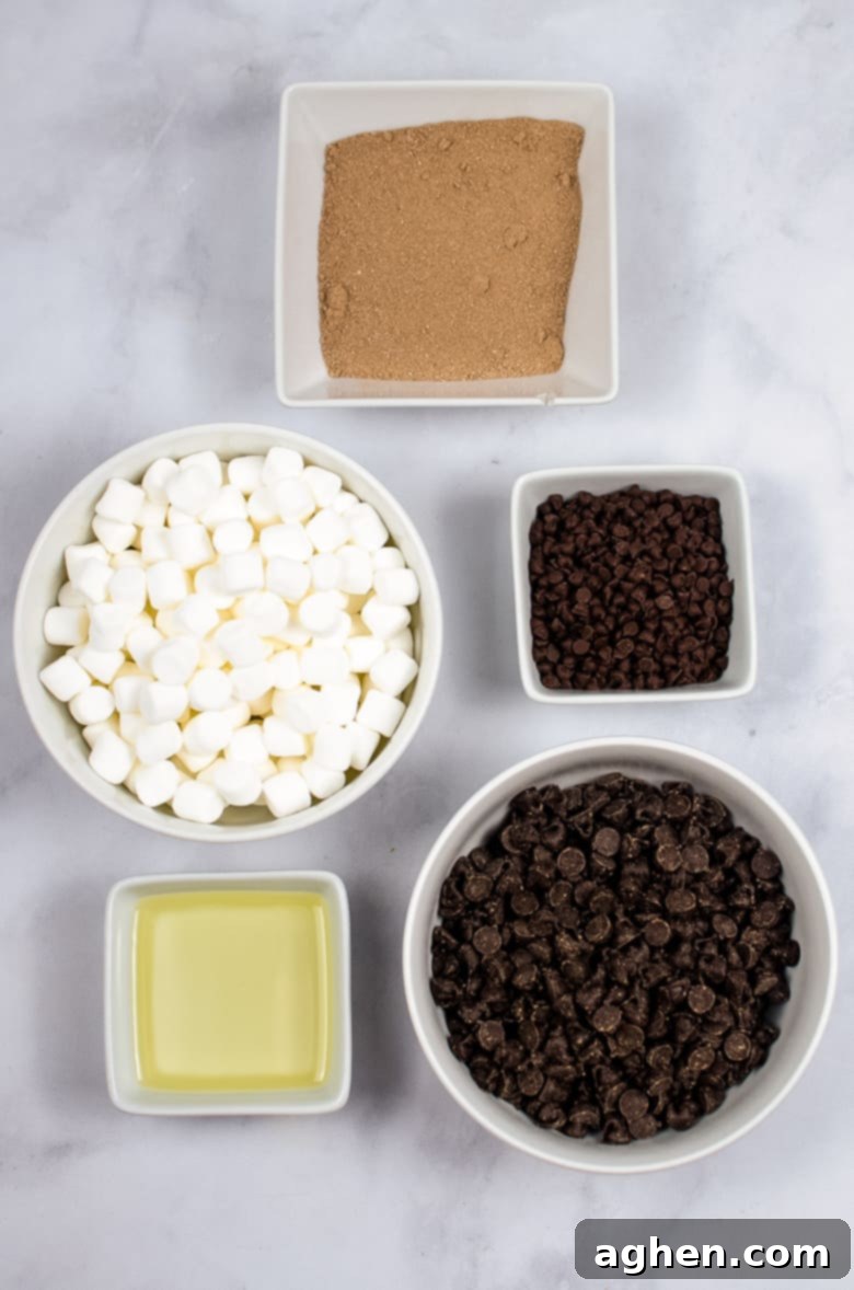 Hot Chocolate Bomb Ingredients laid out, including chocolate, marshmallows, and cocoa mix.