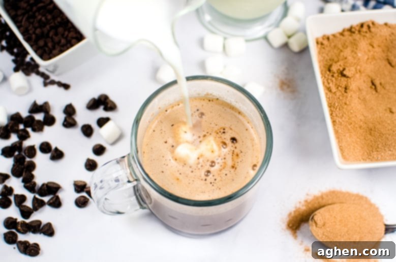 Hot Chocolate Bomb Recipe, showing the delightful process of pouring hot milk over the bomb in a mug.