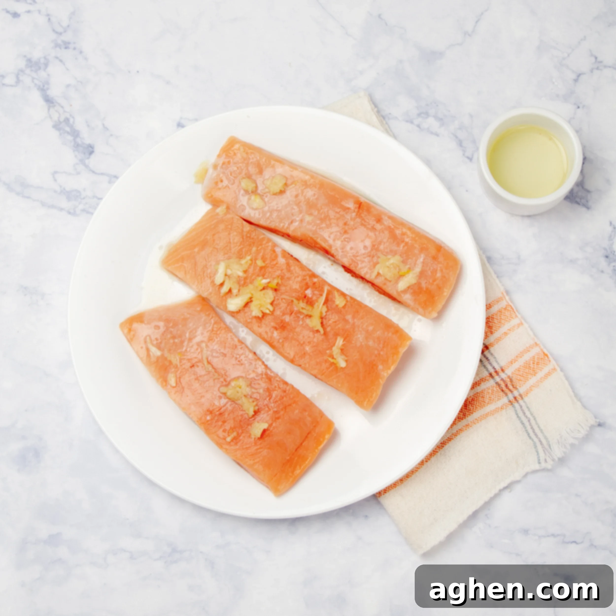 Air Fryer Salmon Perfection 4 Salmon filets topped with seasonings on a plate.