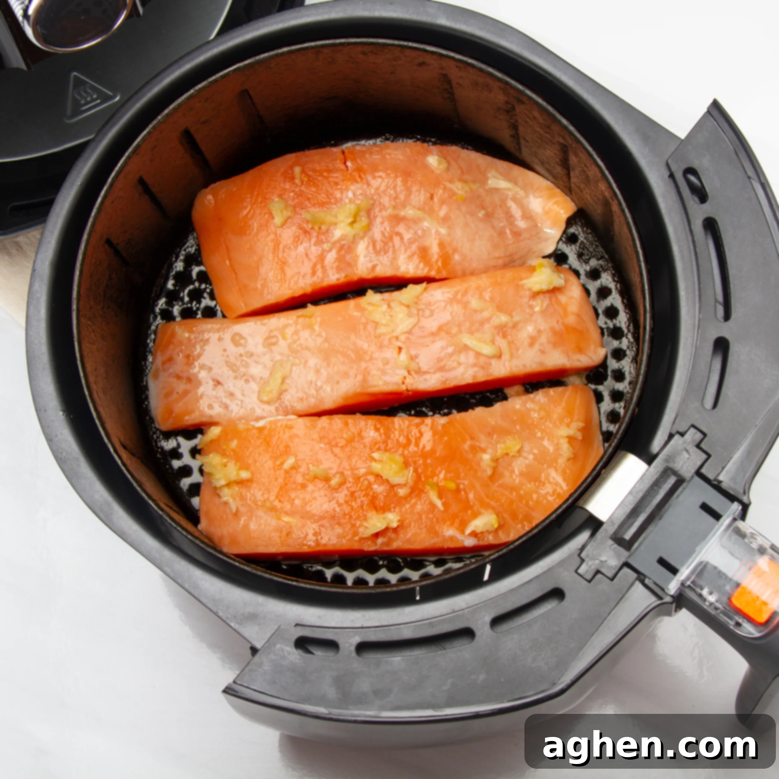 Air Fryer Salmon Perfection 5 Salmon filets in an air fryer basket.