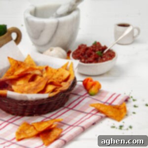 Weight Watchers Diyeti İçin Harika Ev Yapımı Tostitos Atıştırmalığı 7 Crispy homemade Tostitos chips in a bowl with a bowl of salsa on the side.