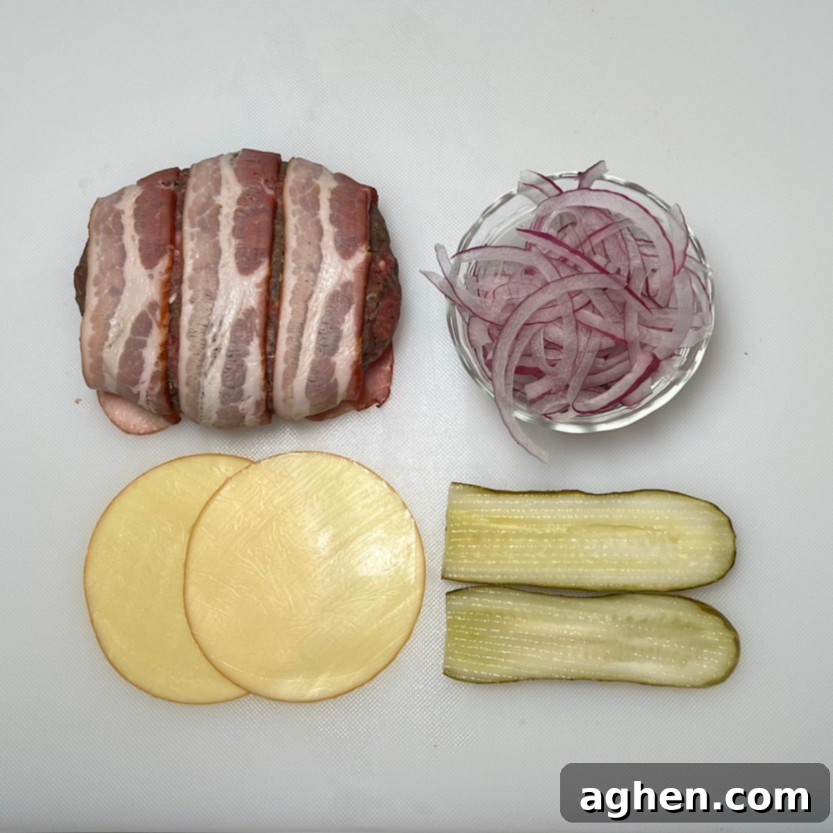 bacon burger with various toppings including lettuce, tomato, onion, and pickles