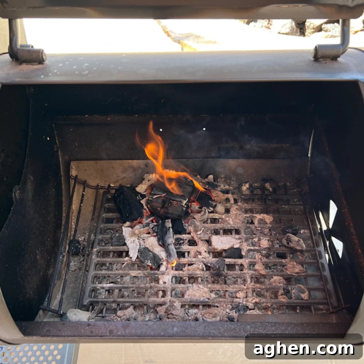 small fire burning in an offset smoker firebox