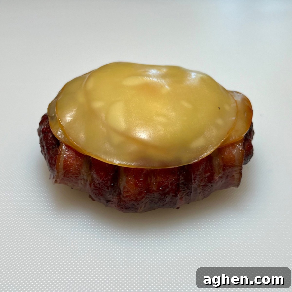 finished smoking bacon burger with melted cheese on a plate