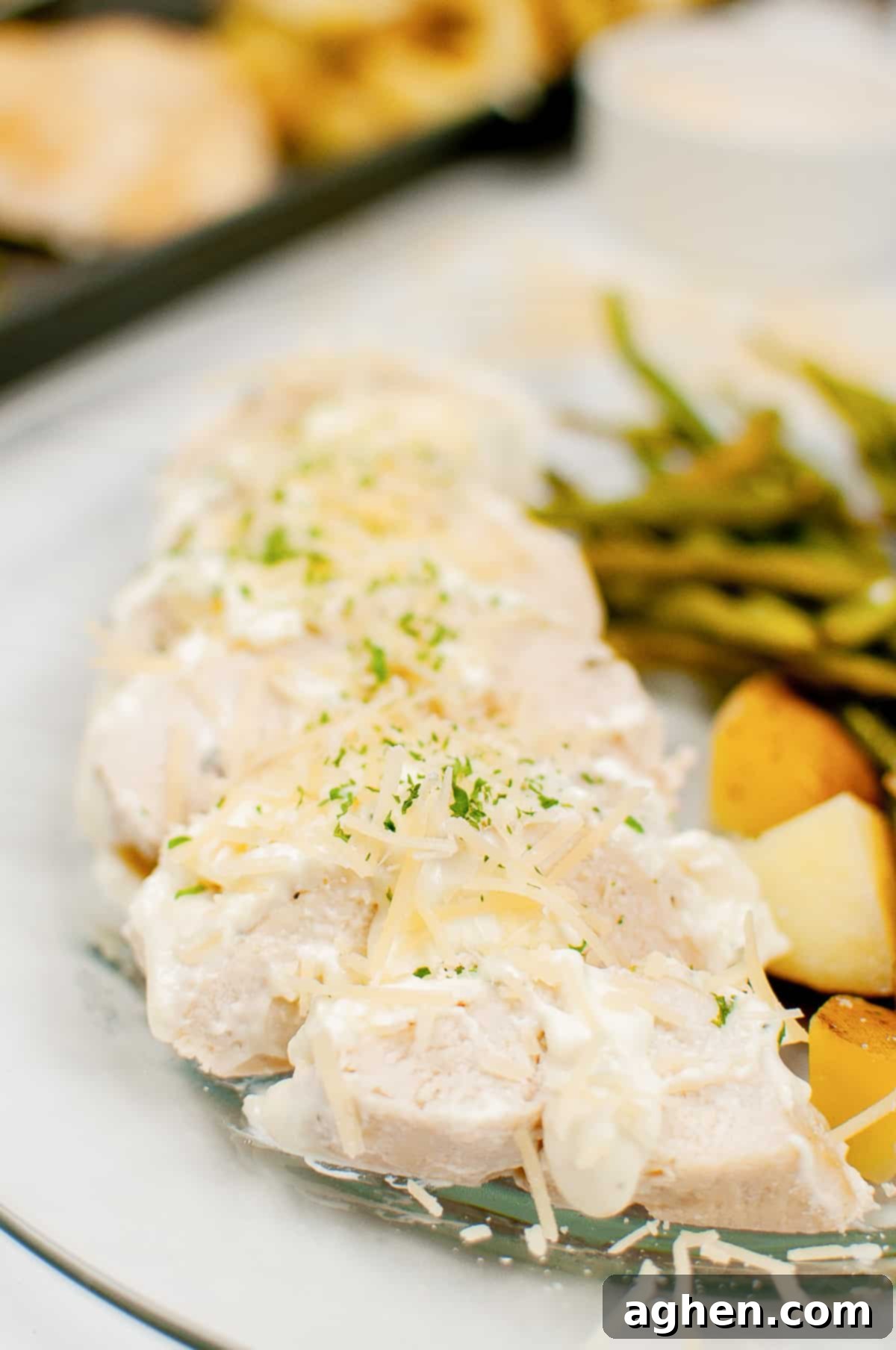 Creamy garlic chicken served with with green beans, potatoes, and topped with a creamy garlic sauce