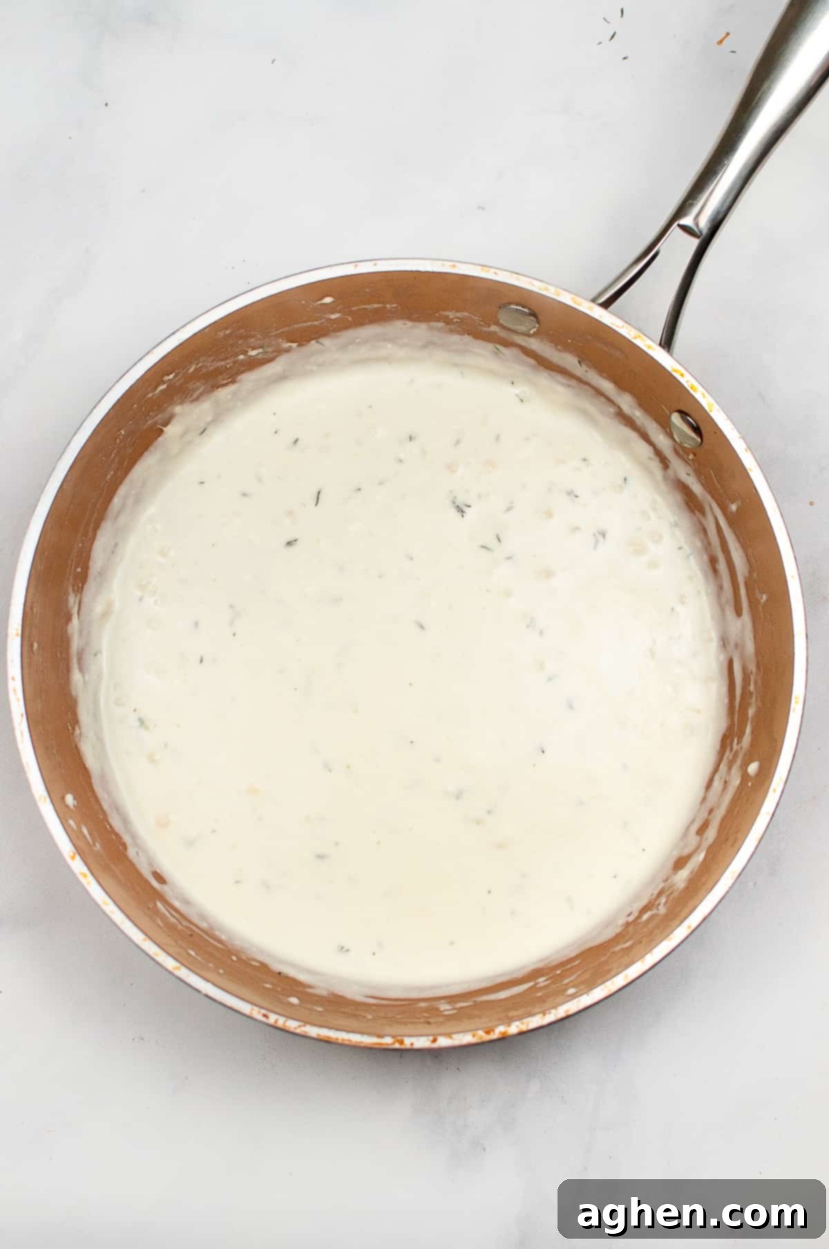 Skillet of creamy garlic sauce