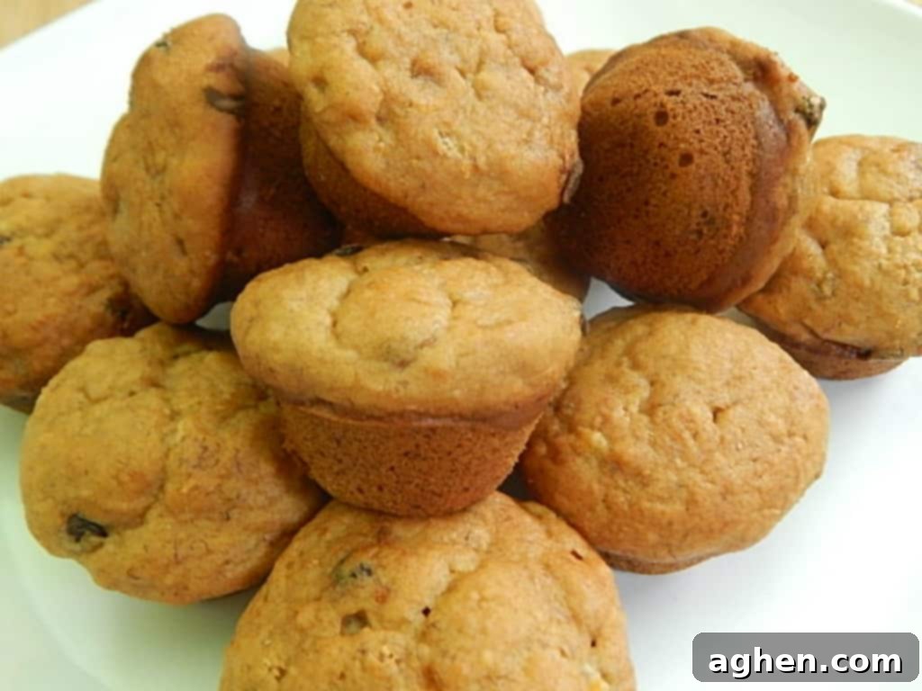 pile of mini peanut butter banana chocolate muffins on a white plate