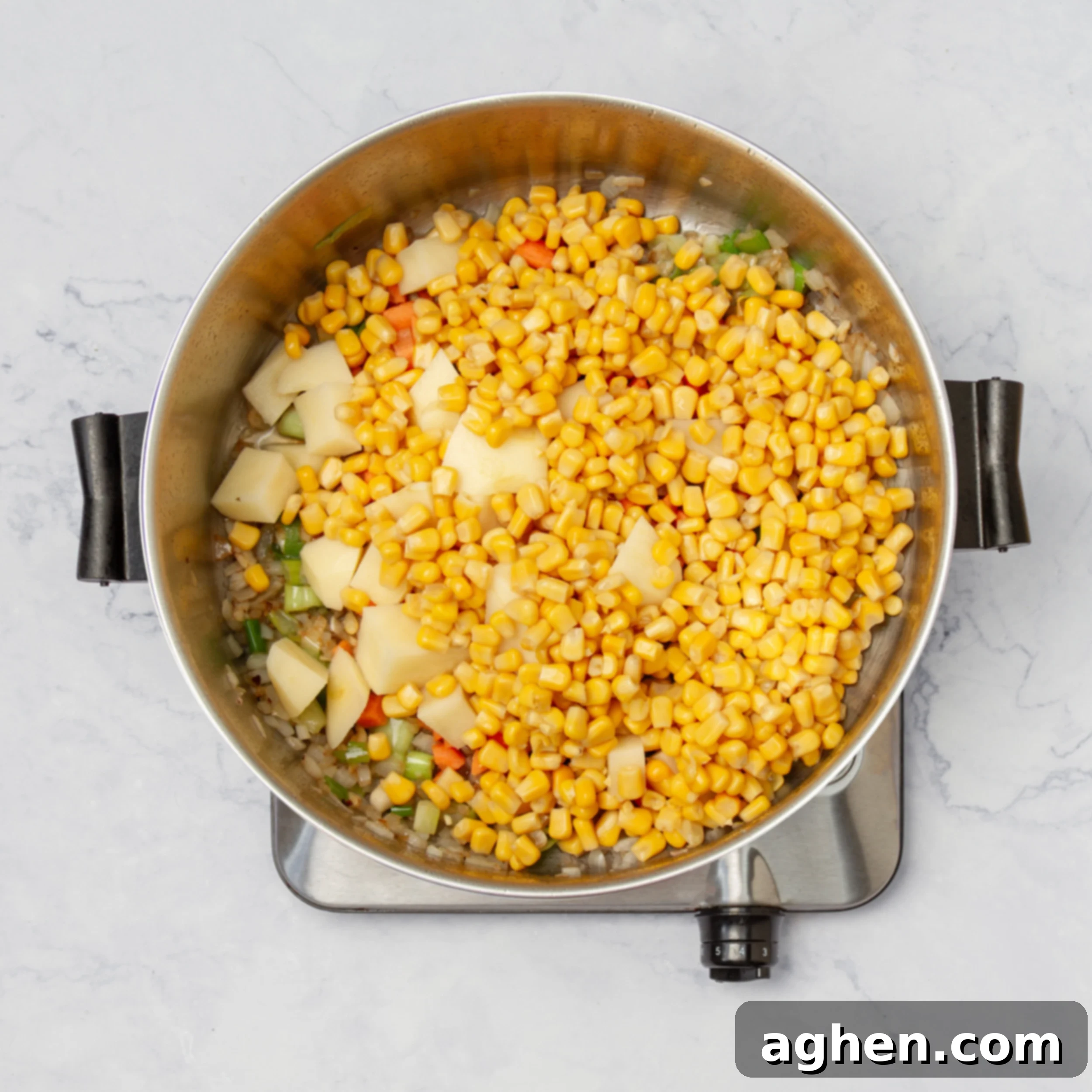 Aromatics and veggies sauteing in a hot soup pot. 