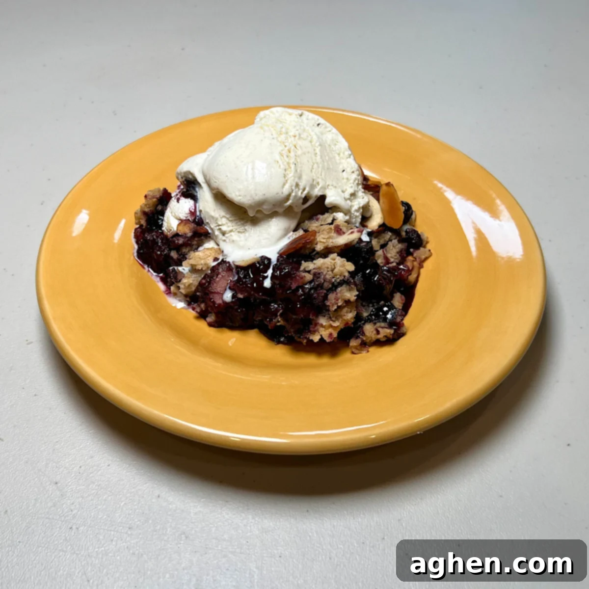 The Ultimate Smoked Blueberry Crumble for Your Grill 2 one slice of blueberry crumble with ice cream