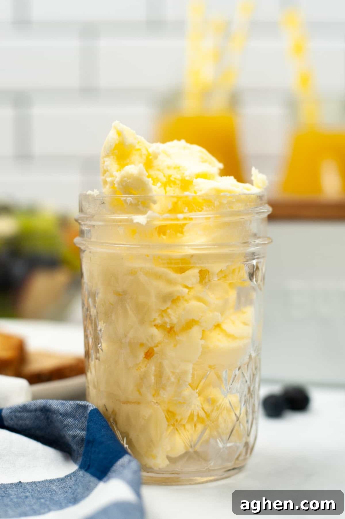 From Cream to Gold 2 Mason jar filled with homemade butter on a kitchen countertop, ready to be enjoyed.