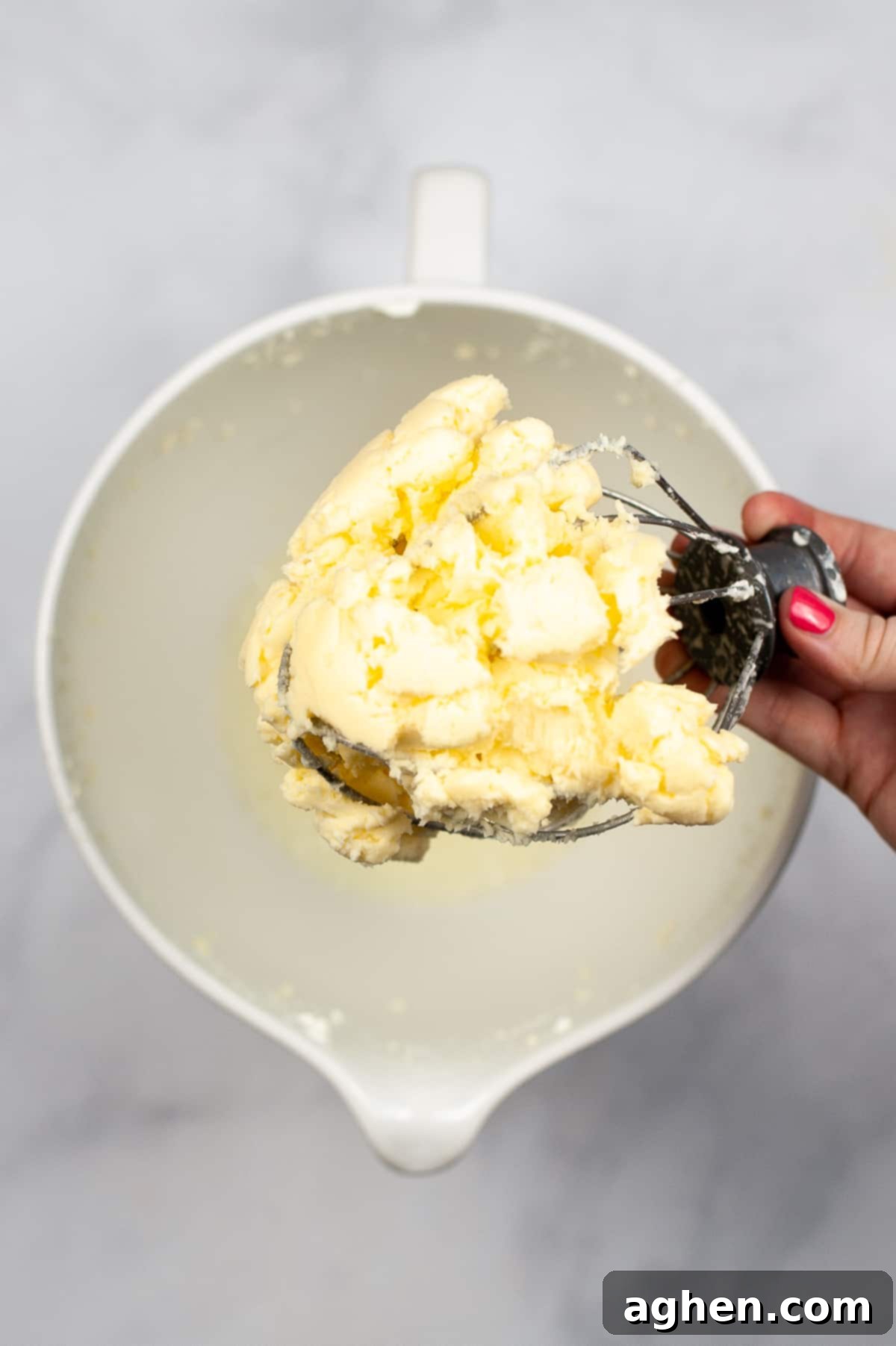 From Cream to Gold 5 Whisk mixer attachment with glob of butter stuck to it, showing the separated butter.