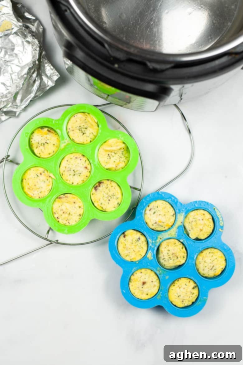 Freshly cooked egg bites in silicone molds, cooling beside an Instant Pot after pressure cooking