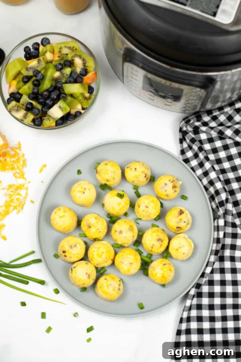 Plate of copycat Starbucks egg bites served with a side of fruit salad, ready for a healthy breakfast