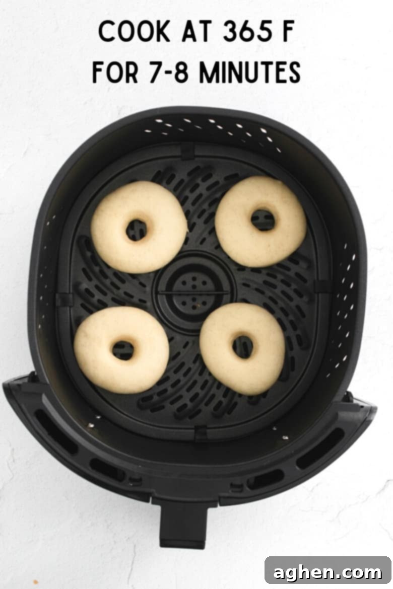 image of donuts in air fryer basket; reads: cook at 365 F for 7-8 minutes