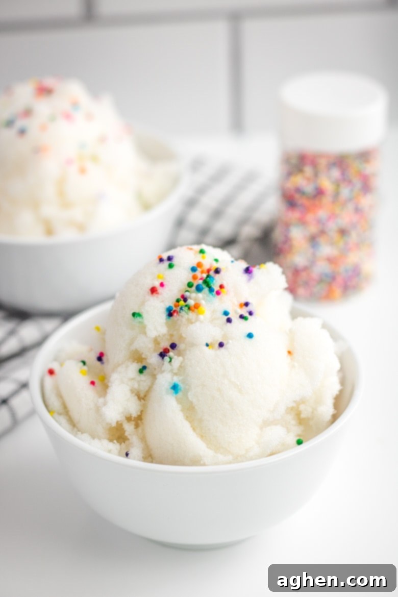 Snow Ice Cream in a white bowl with rainbow sprinkles