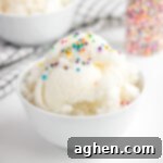 snow ice cream with rainbow sprinkles in a white bowl