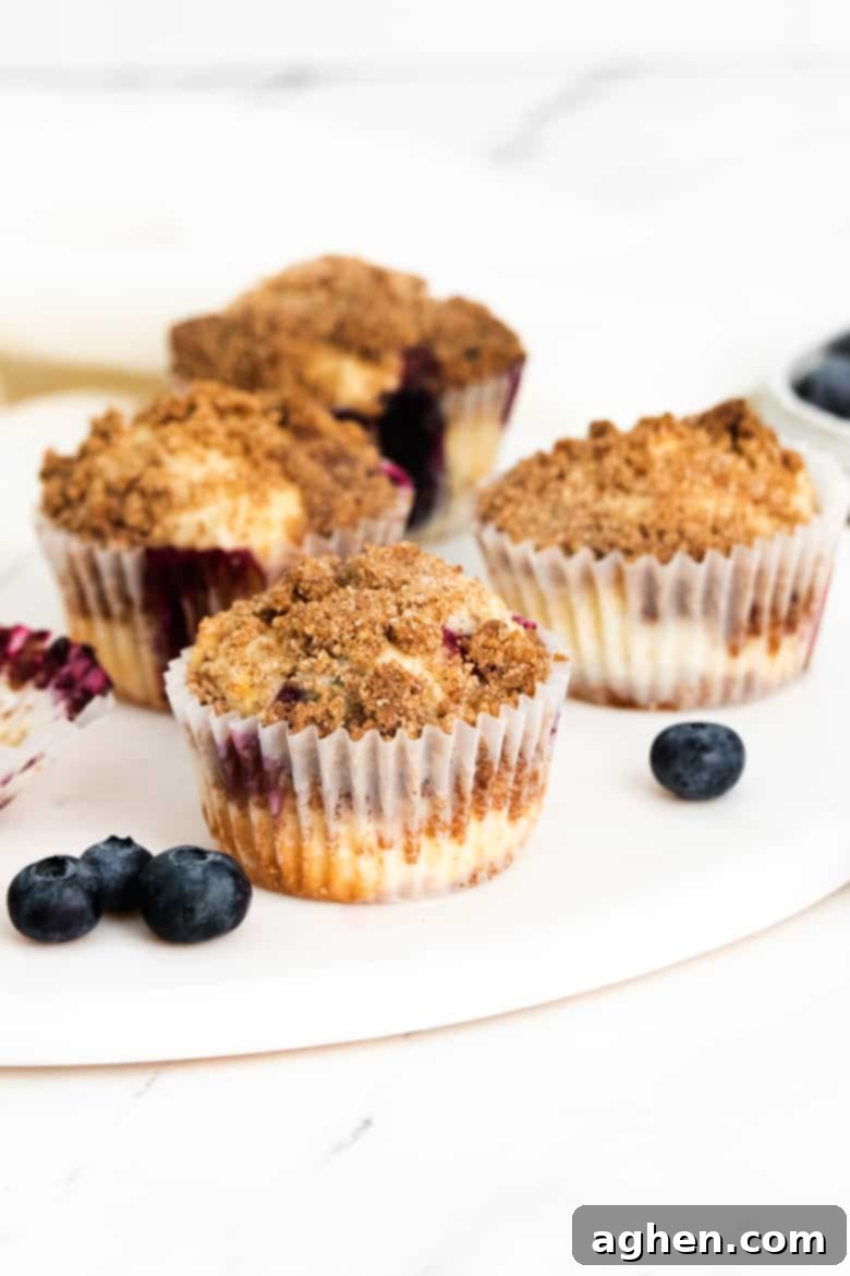 Zesty Lemon Blueberry Crumble Muffins 3 Homemade lemon blueberry muffins with fresh blueberries and crumb topping.