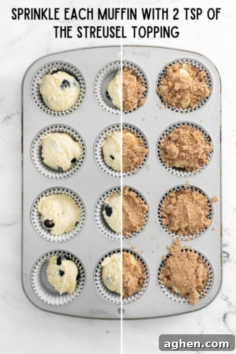 Zesty Lemon Blueberry Crumble Muffins 8 Top view of muffin tin filled with batter. Half the muffins are topped with streusel.