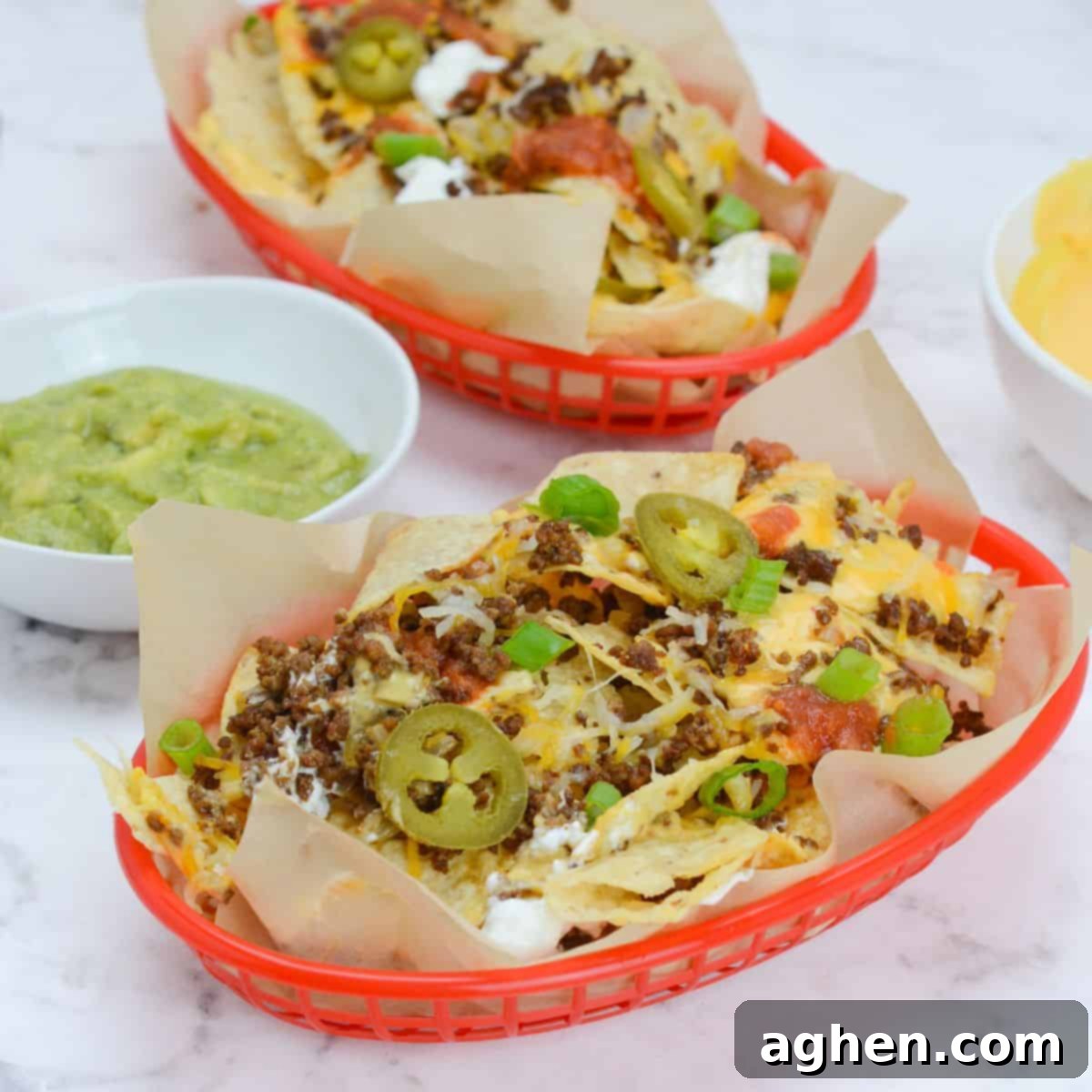 These 15 Recipes Are The Sole Reason My Blackstone Griddle Sees Action In August 2 two baskets of blackstone nachos with a variety of toppings.