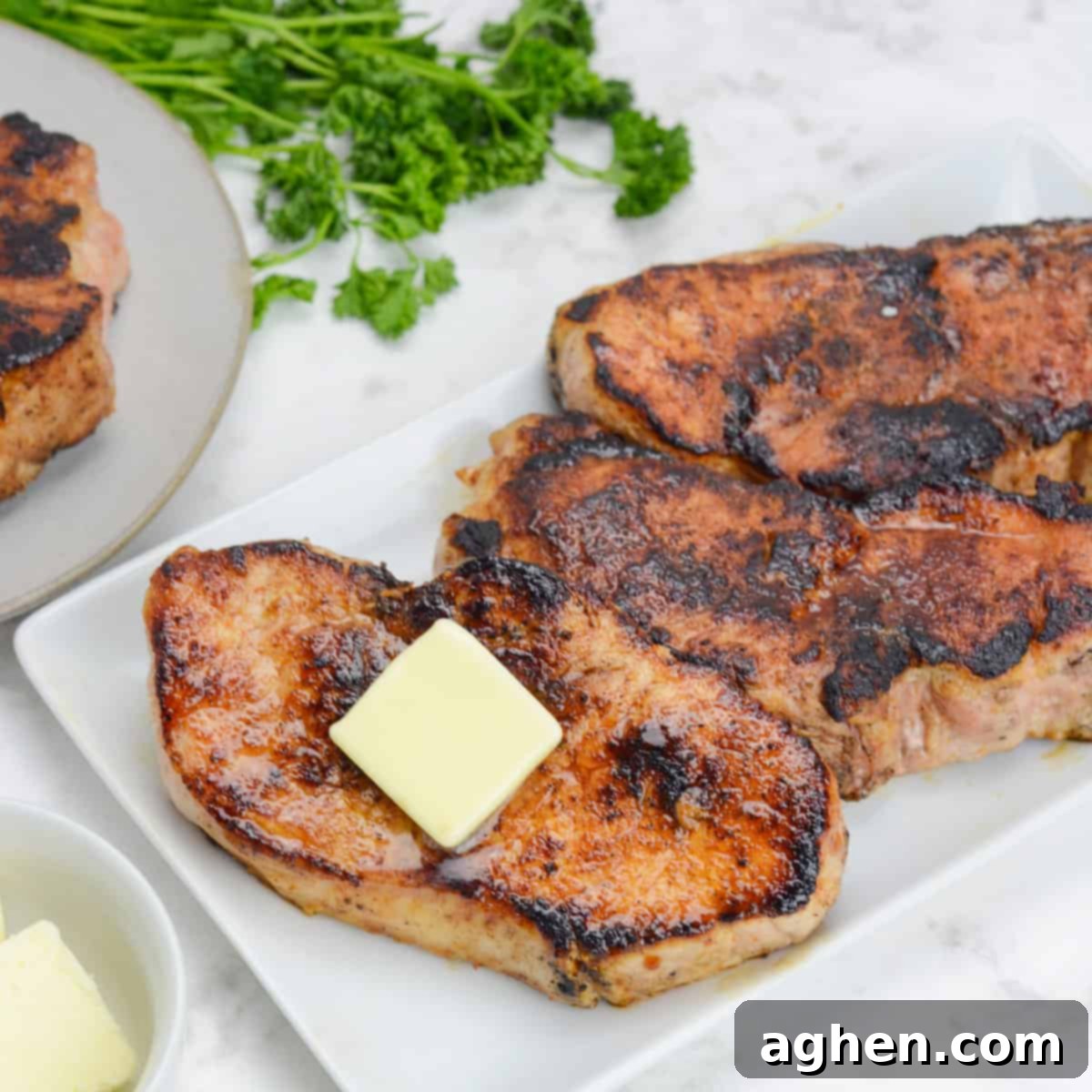 These 15 Recipes Are The Sole Reason My Blackstone Griddle Sees Action In August 5 finished blackstone pork chops, plated on a white platter and topped with butter