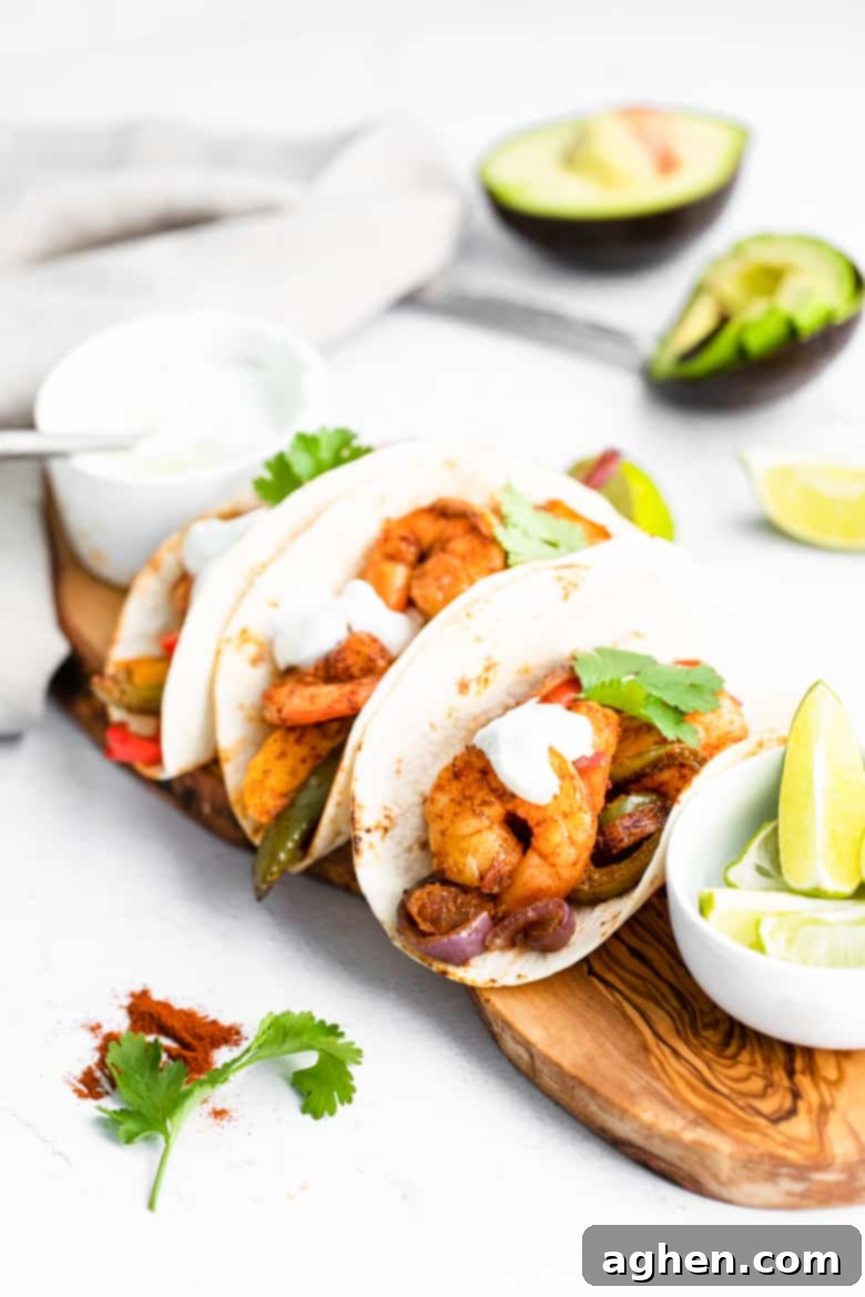 Easy Sheet Pan Shrimp Fajitas 2 Delicious Sheet Pan Shrimp Fajitas ready to be served, showcasing perfectly cooked shrimp, colorful bell peppers, and caramelized onions.