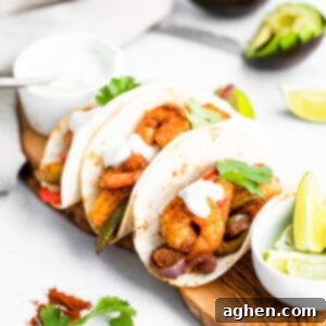 Easy Sheet Pan Shrimp Fajitas 8 Sheet Pan Shrimp Fajitas served in flour tortillas topped with fresh cilantro and sour cream