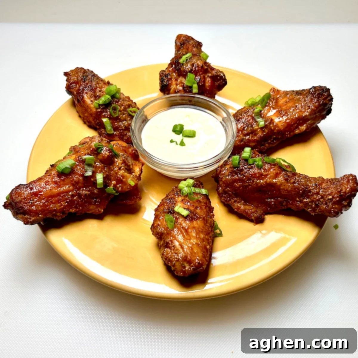 finished chicken wings on yellow plate