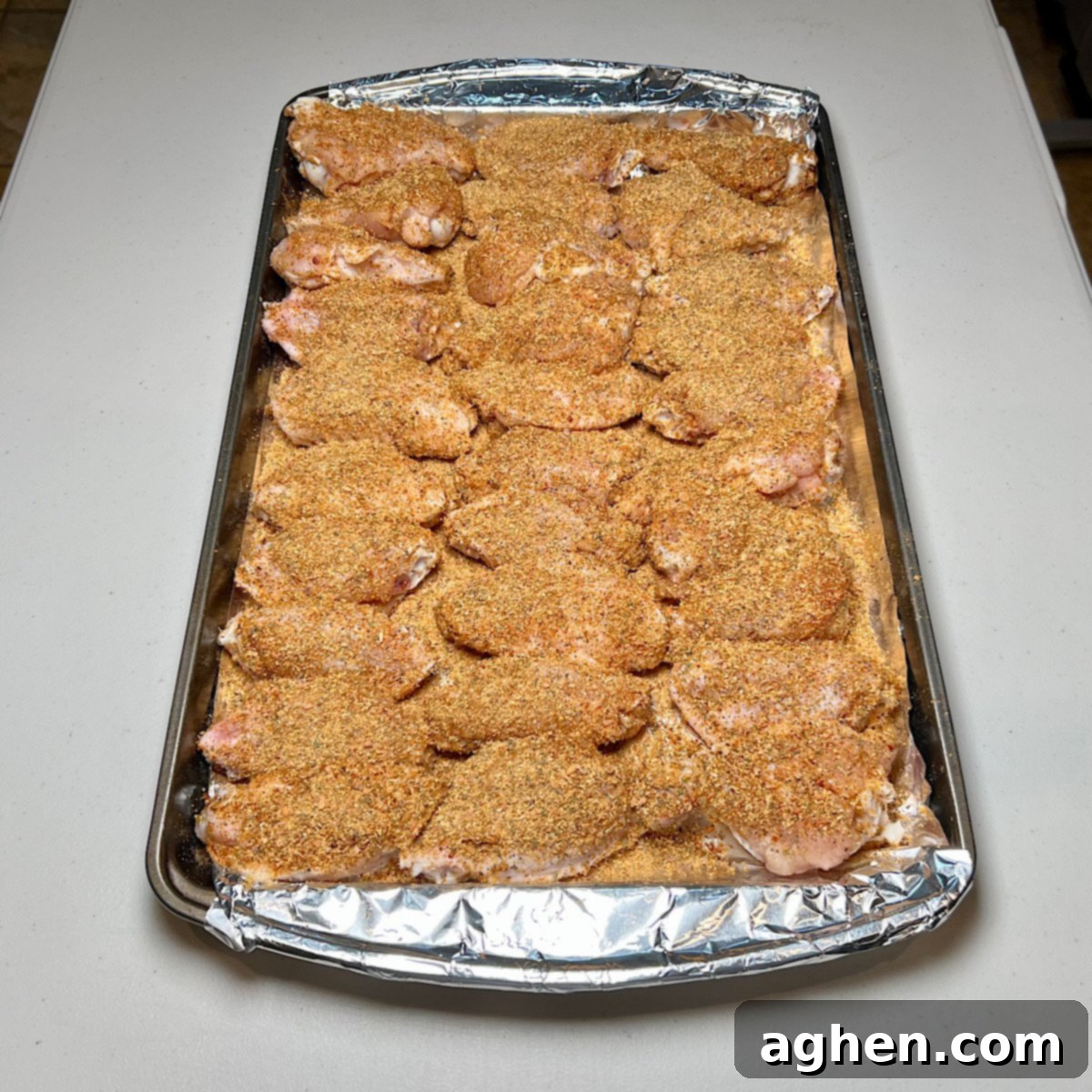 rubbed chicken wing on a tray
