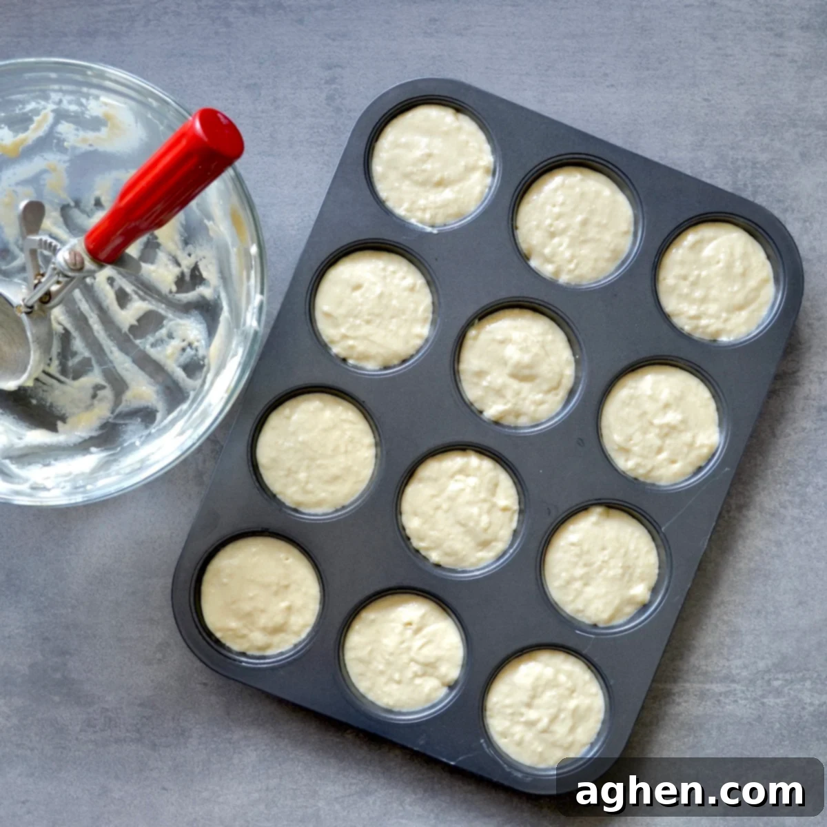 Guilt-Free Honey Muffins 5 Scooping honey muffin batter into a paper-lined muffin tray