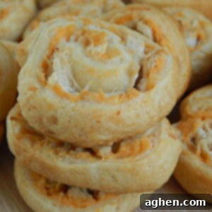Zesty Buffalo Bites 2 A freshly baked Buffalo Chicken Pinwheel showing its vibrant filling and flaky crust.