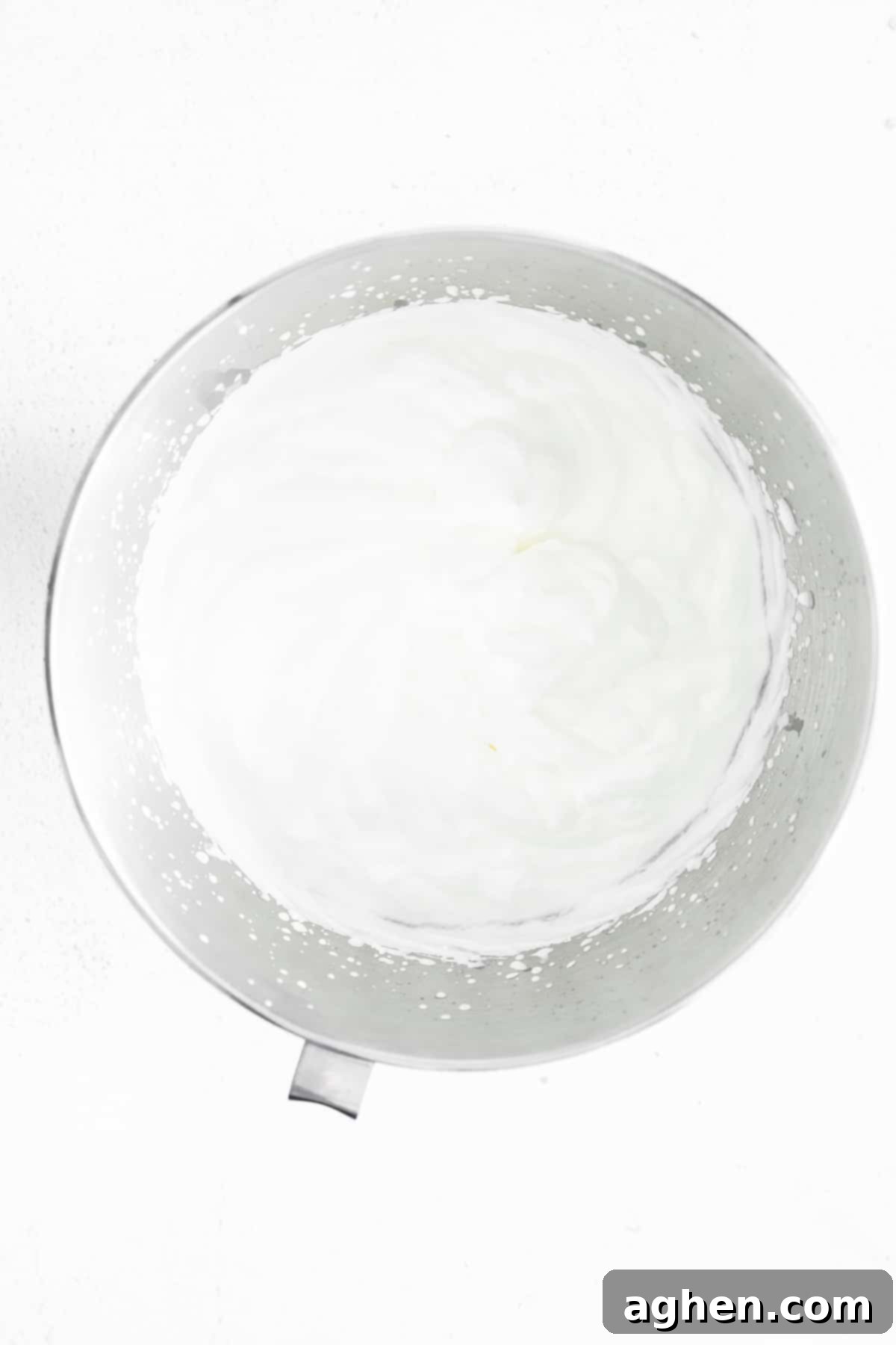 whipped cream in metal mixing bowl
