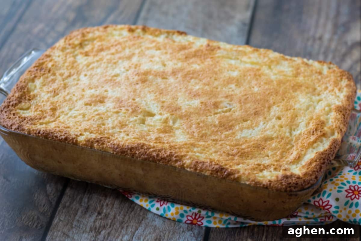 The baked 2-ingredient pineapple angel food cake in a rectangular glass baking dish, fresh from the oven.