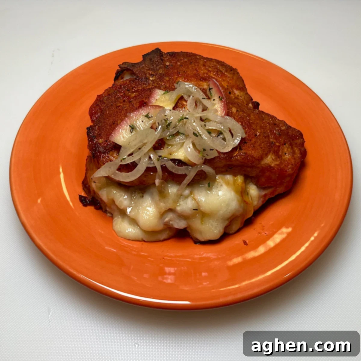 finished stuffed pork chop on plate