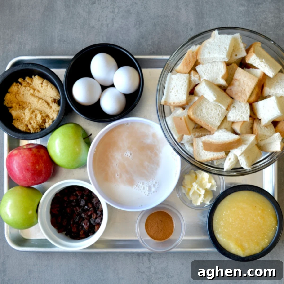 Fresh ingredients laid out for making healthy apple raisin bread pudding