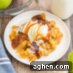 Apple dump cake topped with vanilla ice cream and caramel sauce.