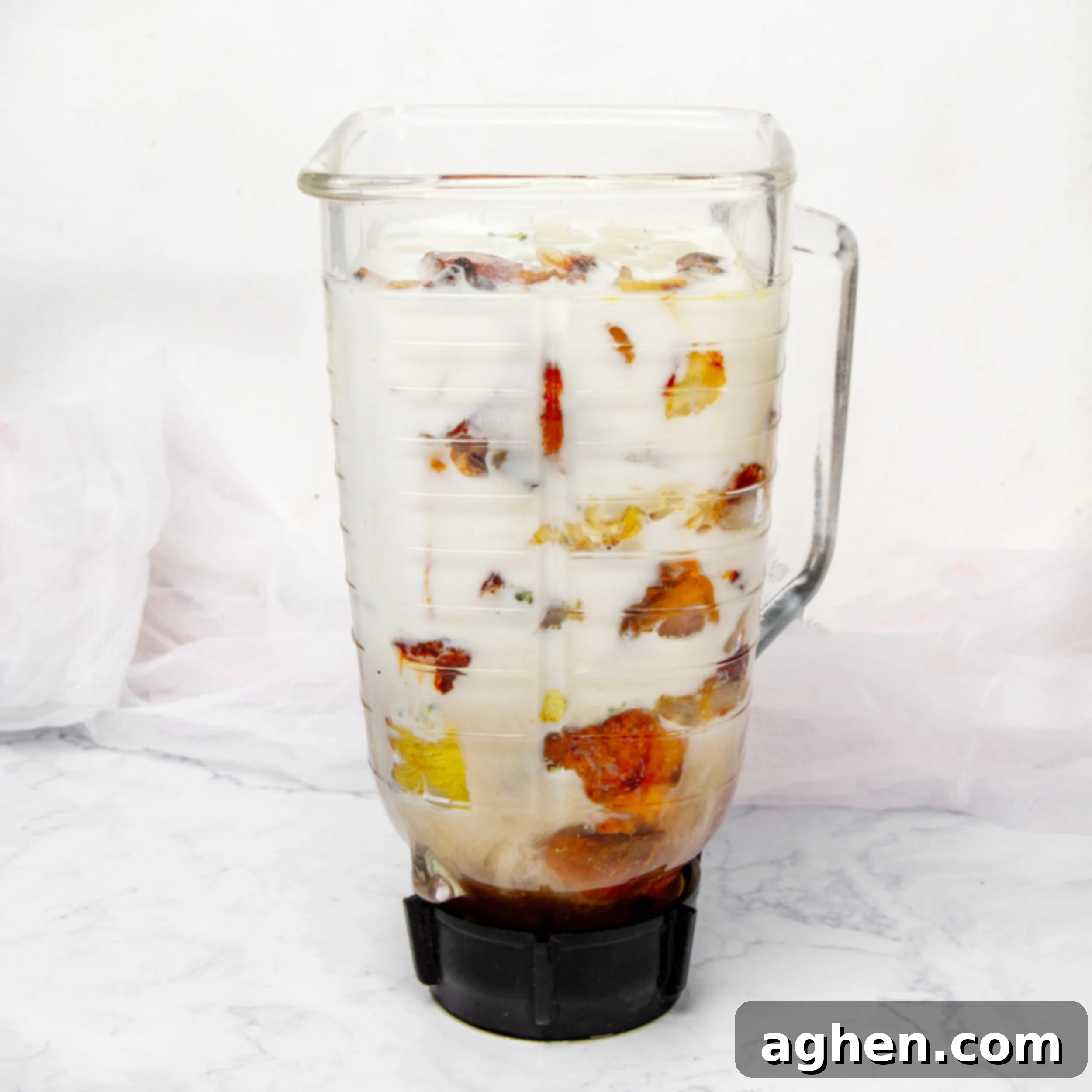 Roasted vegetables in a blender with milk and broth. 