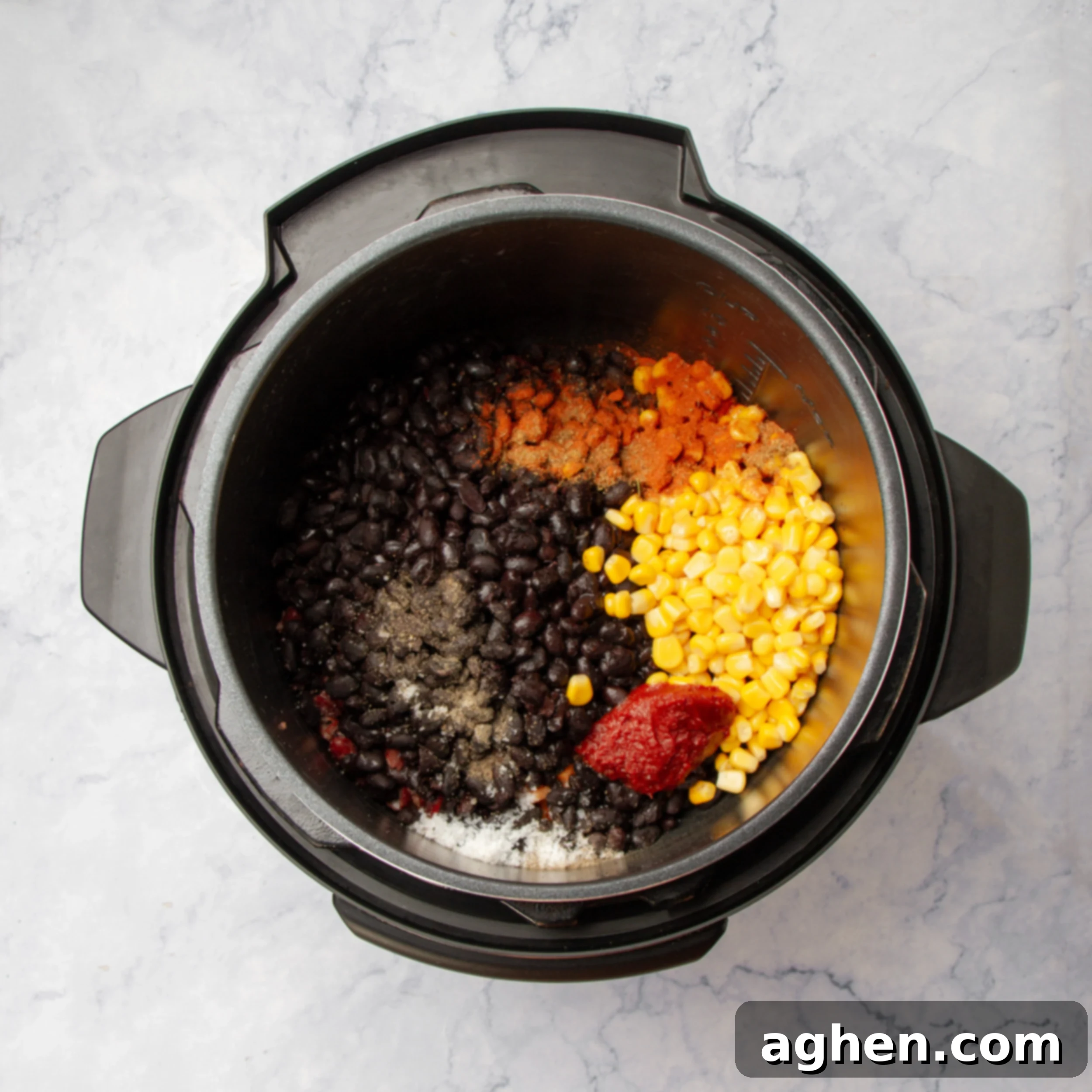Hearty Instant Pot Vegan Chili 5 Beans and corn added to the base of sauteed veggies and aromatics in an Instant Pot.