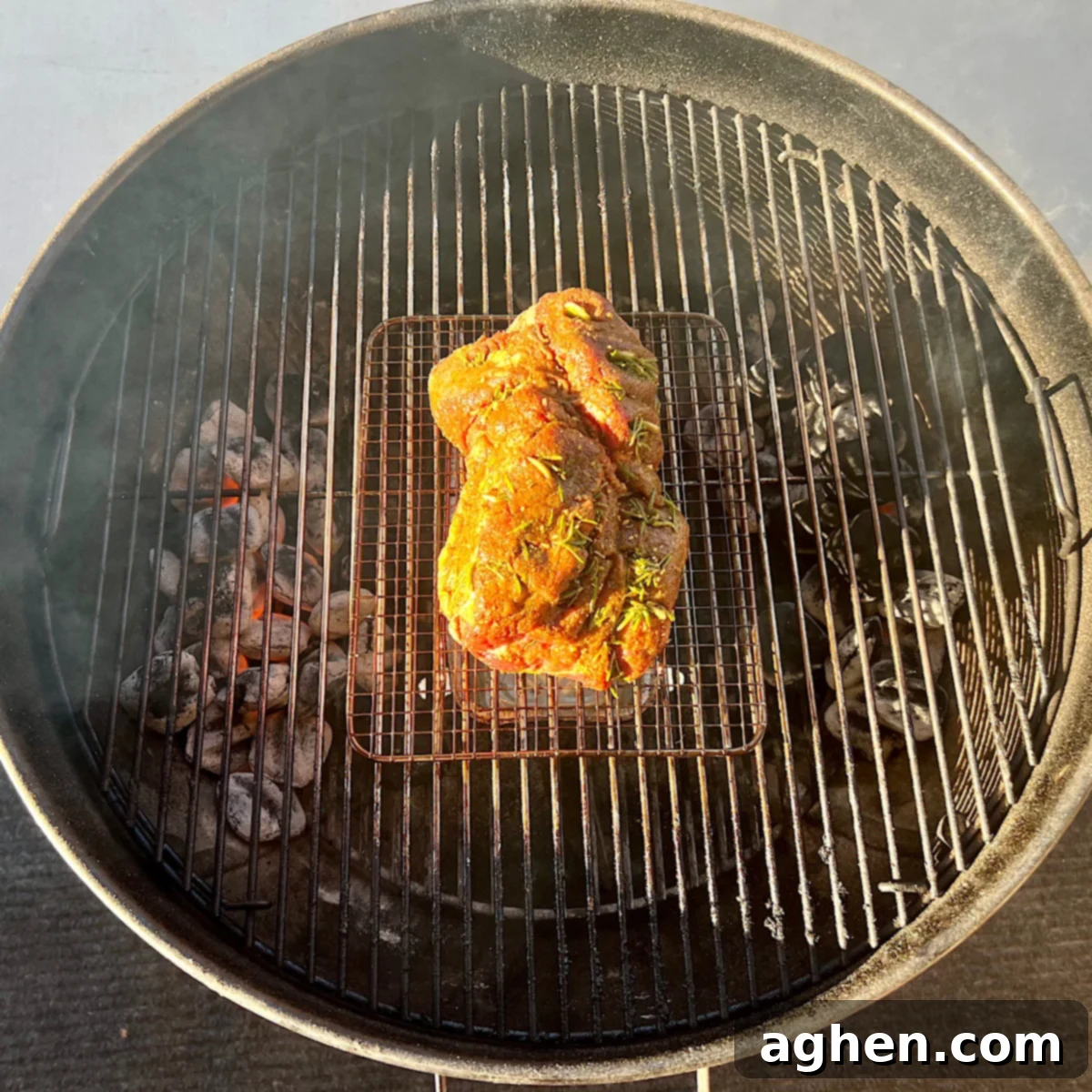 raw leg of lamb on grill grate