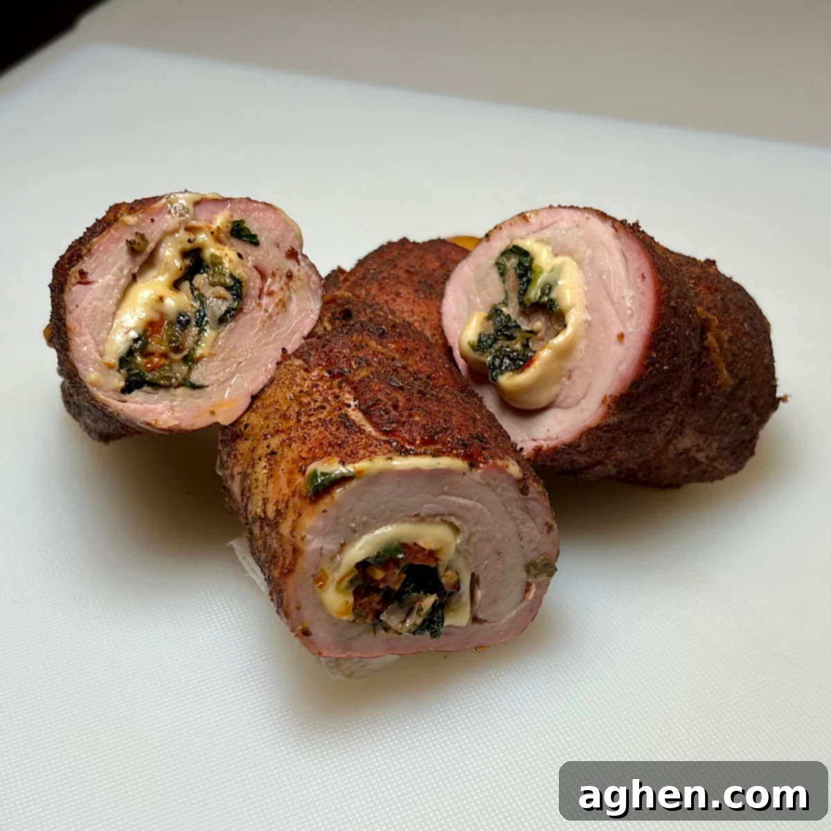 Finished smoked stuffed pork tenderloin, sliced into four delectable pieces, ready to serve.