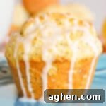 A beautifully glazed lemon poppy seed muffin, inviting and perfectly baked.
