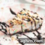 Frozen Dream Pie 14 Slice of ice cream pie drizzled with chocolate sauce and topped with sprinkles and sliced almonds
