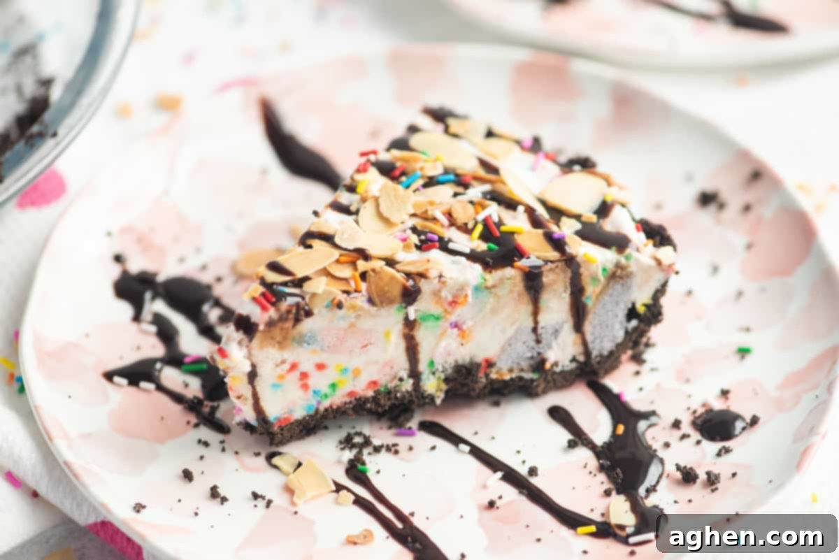 Frozen Dream Pie 5 Slice of ice cream pie drizzled with chocolate sauce and topped with sprinkles and sliced almonds
